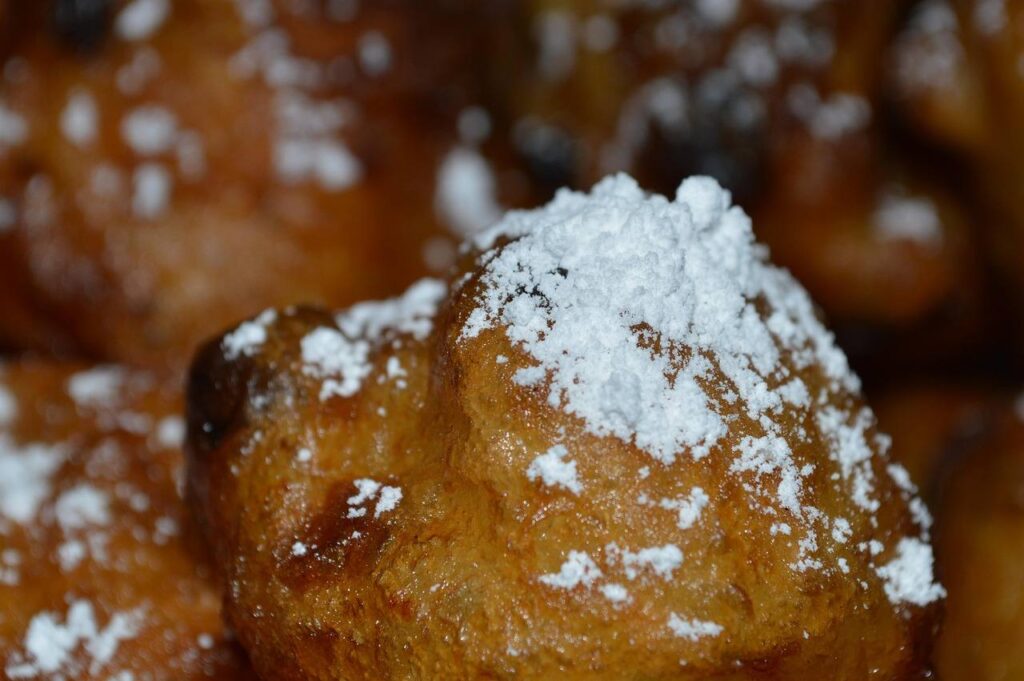 Fried yeast dough dusted with powdered sugar
