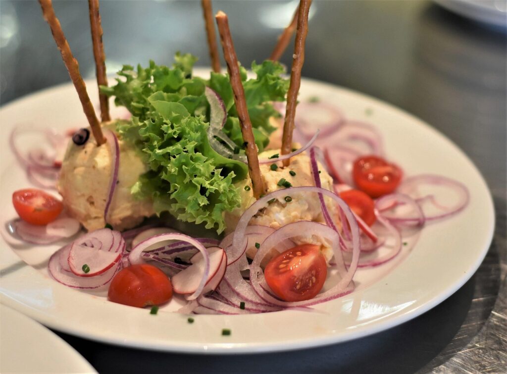 A Bavarian Brotzeit plate with Obatzda, a pretzel and radish