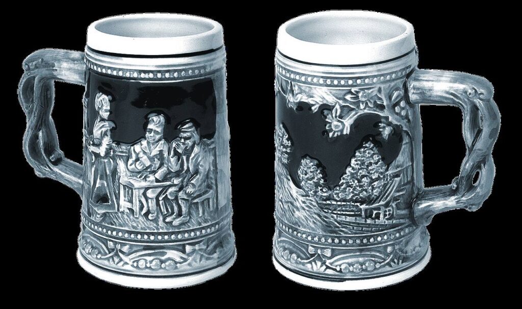A pewter relief beer stein