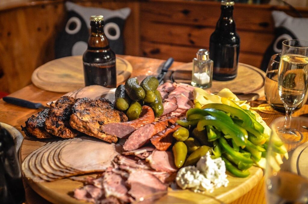 A delicatessen counter with smoked meats and sausages