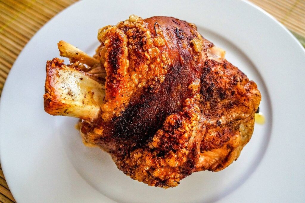 A crispy roasted pork knuckle on a plate